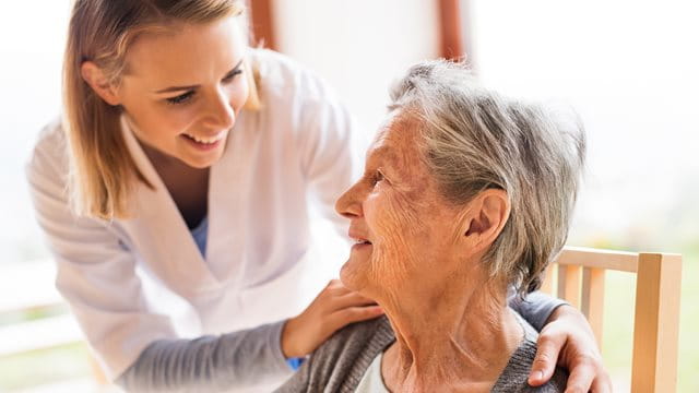 Health visitor and a senior woman during home visit. Health visitor and a senior woman during home visit.